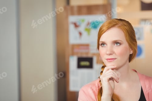 Preview: Thoughtful woman in office with hand on chin, planning creative ideas, copy space