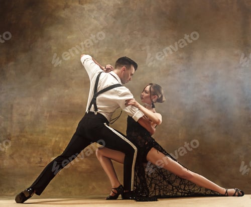 Preview: Flexible young modern dance couple posing in studio.