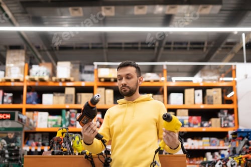 Preview: the buyer is determined between two models of screwdrivers and drills in the tool department of a