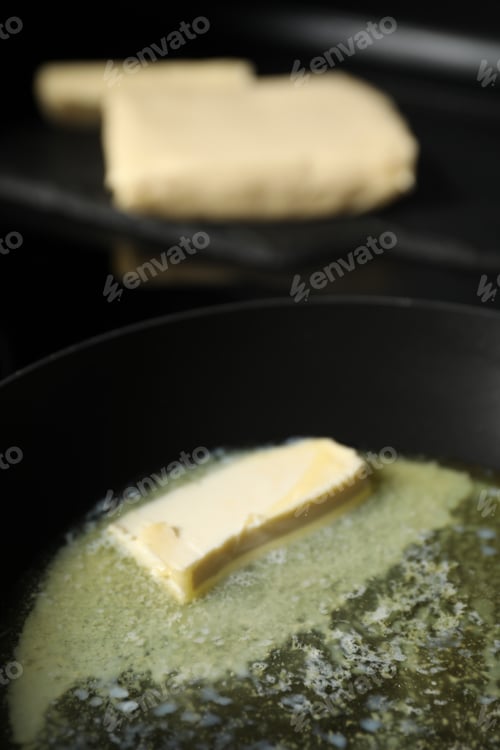 Preview: Melting butter in frying pan on table, closeup