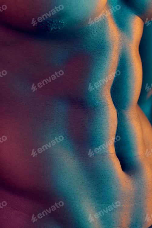 Preview: Abs-olutely perfect. Shot of a muscular man posing against a studio background.