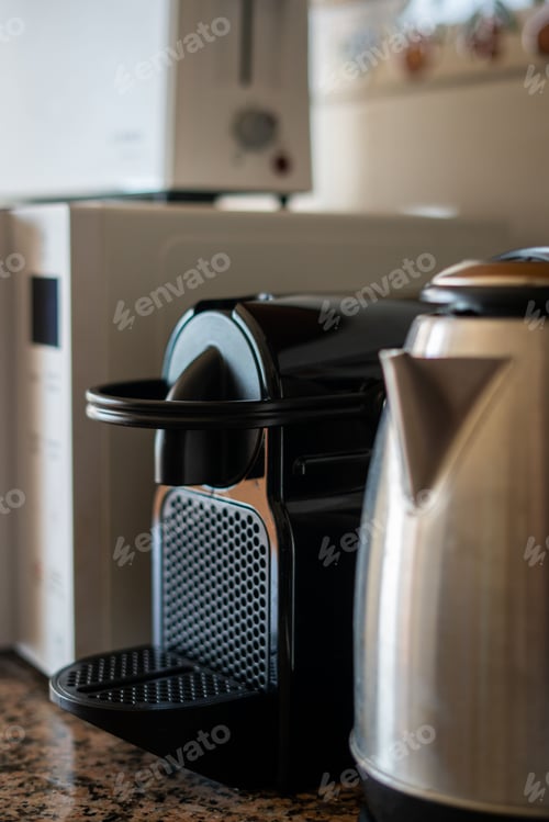 Preview: A coffee maker, a microwave and an electric kettle on the shelf in the kitchen