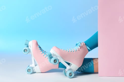 Preview: Woman with vintage roller skates on color background, closeup. Space for text