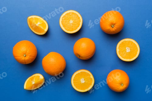 Preview: Fruit pattern of fresh orange slices on colored background. Top view. Copy Space.