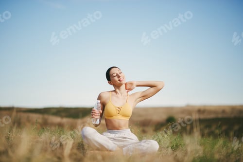 Cute girl training on a sky backgroung in a field