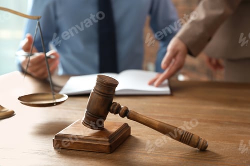 Preview: Notaries working at table in office, focus on judge gavel. Law and justice concept