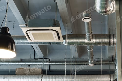 Preview: Silver ventilation pipes hanging from the ceiling inside the building