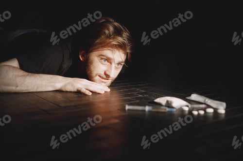 Preview: Junkie man reaches for syringe with dose
