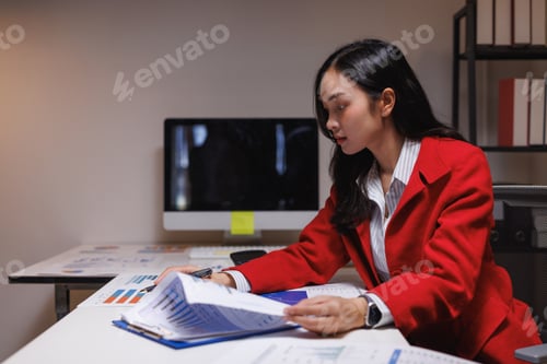 Preview: Businesswoman analyzing corporate financial data in office