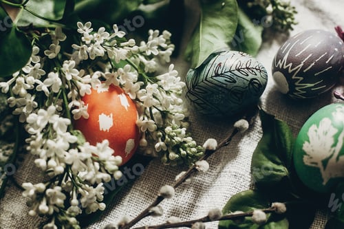 Preview: easter eggs with lilac flowers on rustic background