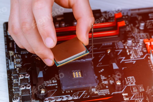 Preview: The technician is putting the CPU on the socket of the computer motherboard