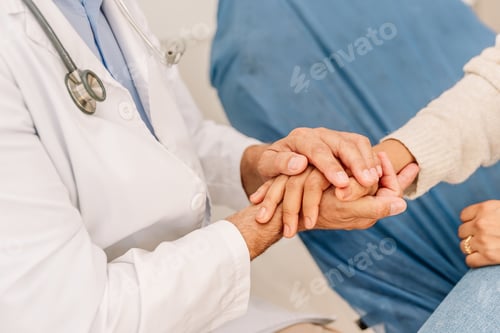 Preview: unrecognizable doctor holds the patient's hands. He gives him hope and supports him.