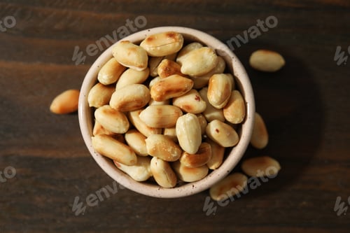 Preview: Roasted peanuts in bowl on wooden table, top view