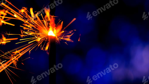 Preview: Bright sparks slowly fly from bright burning bengal light stick