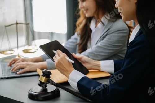 Preview: business people and lawyers discussing contract papers sitting at the table.