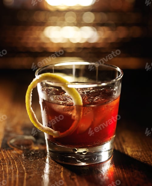 Preview: sazerac cocktail on dark wooden background with warm glow