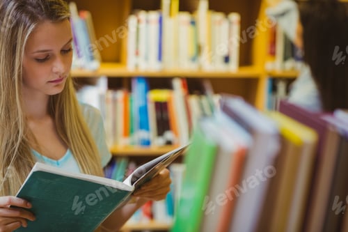 Preview: Pretty Young Blonde Reading Book In Library