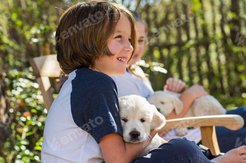Preview: 6 year old boy holding an English golden retriever puppy