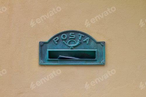 Preview: mailbox in Italy with inscription in Italian the word posta means mail on yellow wall of the house