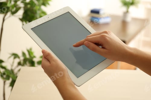 Preview: Young woman using new modern tablet indoors, closeup