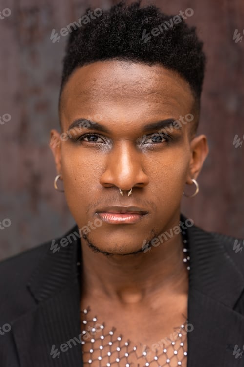 Preview: Portrait of a black ethnic man in a fashion pose on a metallic background with rust