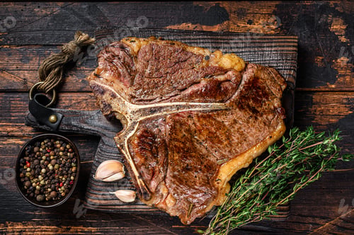 Preview: Roast t-bone or porterhouse beef meat Steak on a wooden cutting board.