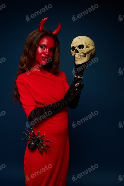 Preview: A captivating woman showcases her enchanting Halloween costume with a skull and spider details