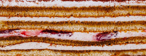 Preview: Delicious cake with layers of biscuit, cream and fruit jelly is waiting to be eaten