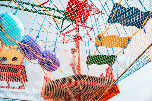 Preview: Small children have fun in rope amusement park. Suspended rides on top. Obstacle course, ladder, ste