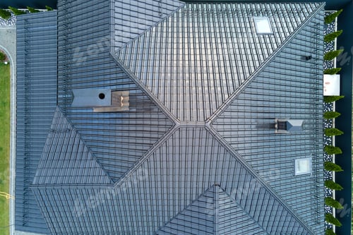 Preview: Closeup of house roof top covered with shiny ceramic shingles