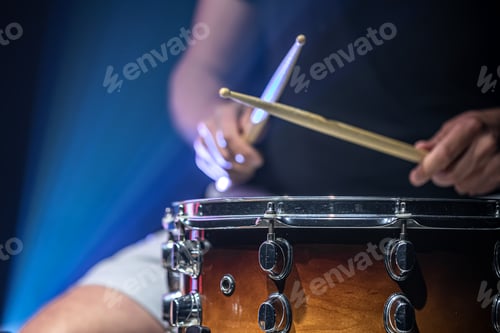 Preview: Close-up shot of a drummer playing a snare drum with sticks.