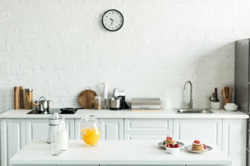 Preview: interior of kitchen with yummy pancakes and orange juice on kitchen counter