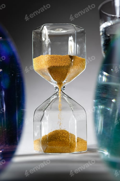 Preview: Hourglass with sand on gray background close up