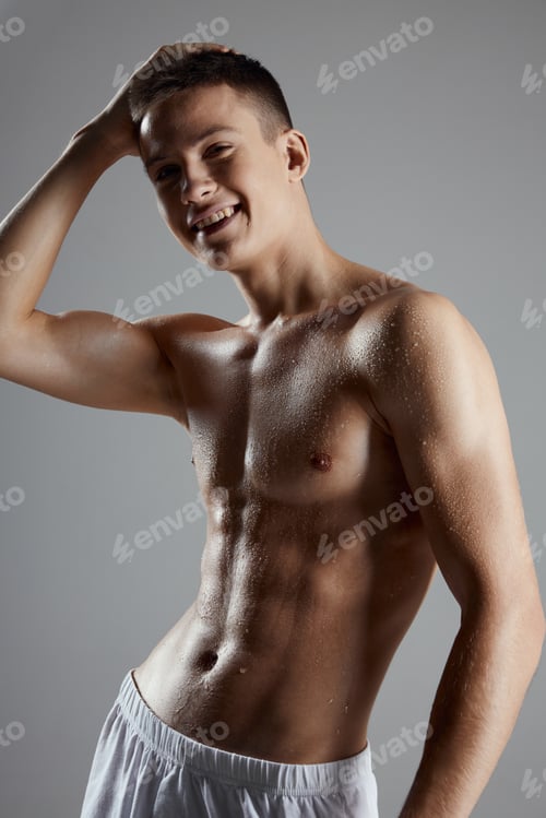 Preview: an athlete in white shorts and with a naked torso holds his hand on his head