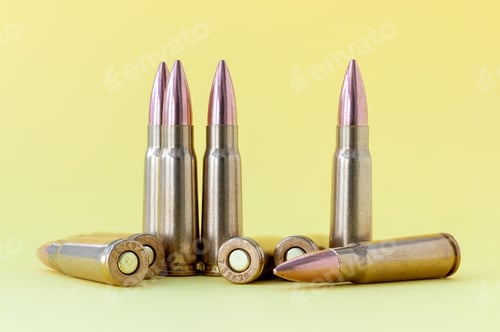 Preview: Bullets on yellow background. Cartridges 7.62 caliber for Kalashnikov assault rifle