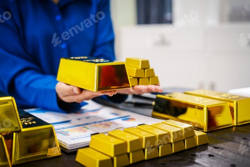 Preview: An Asian business woman sitting at her desk in office,analyzing gold bullion prices,market trends