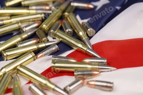 Preview: Many yellow 9mm and 5.56mm bullets and cartridges on United States flag