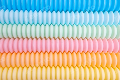 Preview: Trendy kids toys pastel colorful pop-tube on beige background. Set of forms and colors