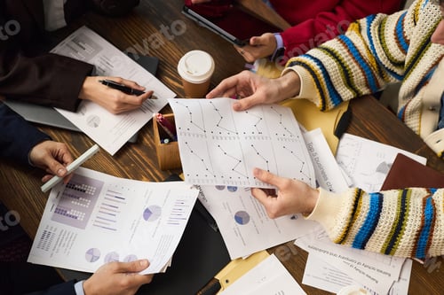 Preview: Multiethnic Group of Young Adults Analyzing Business Charts during Meeting