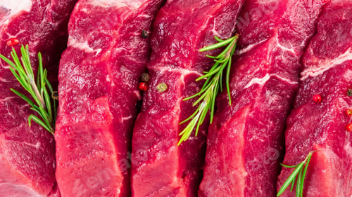 Preview: background of fresh raw sliced beef steaks, garlic, rosemary and seasonings. Juicy meat banner