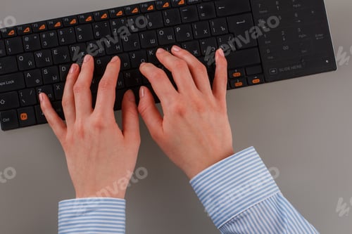 Preview: Close up female hands working on computer keyboard.