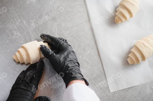 Preview: Baker making croissant dough in bakery kitchen