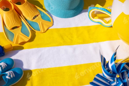 Preview: Beach accessories on yellow striped towel