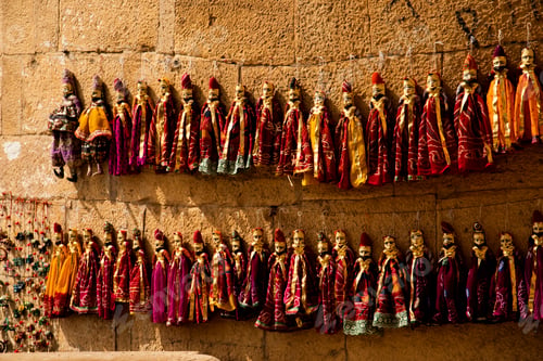 Preview: Colorful Rajasthani puppets hanging in the street of Jaisalmer, India.