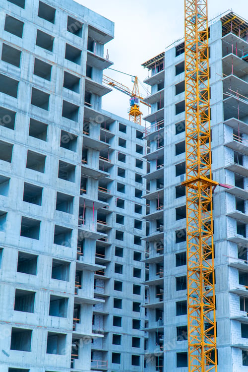 Preview: Yellow crane in front of the concrete building under construction