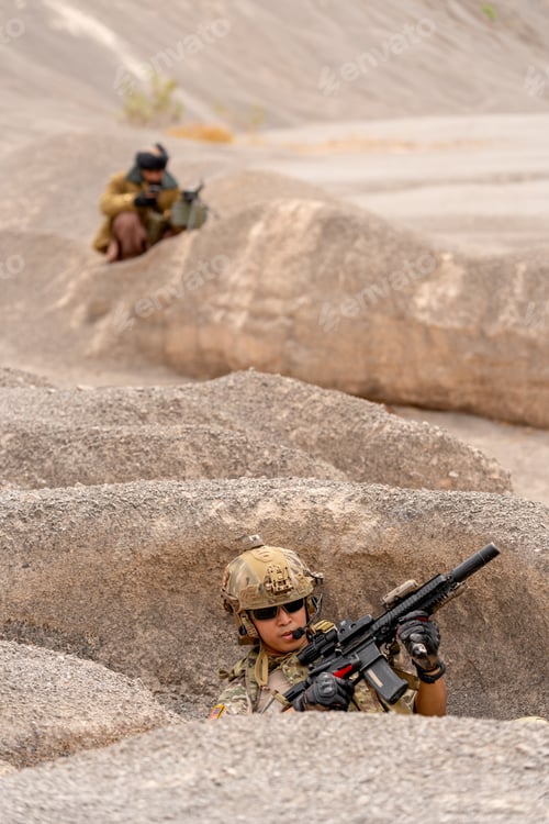 Preview: Vertical image military or soilder man hold gun and sit in the pit or slope in front of terrorist