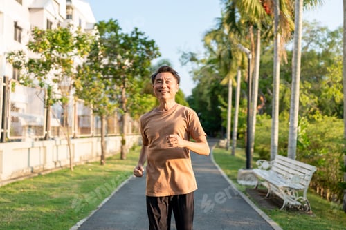 Preview: Asian senior elderly sportsman running exercise outdoors in the garden.