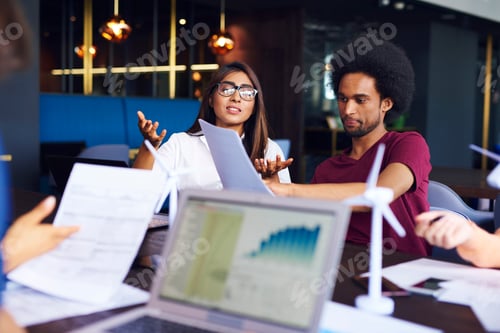 Preview: Young business couple doing analysis