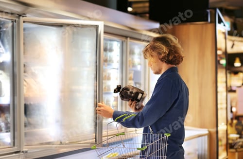 Preview: Man Choosing Frozen Food From A Supermarket Freezer