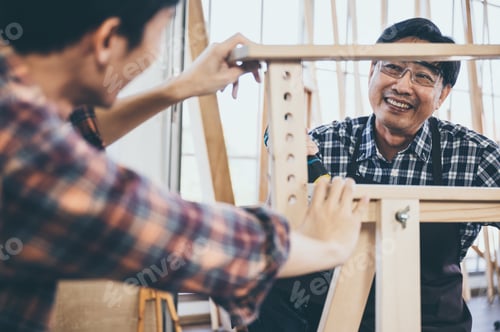 Preview: Craftsman carpenter team cooperating on building construction planning, working with wood